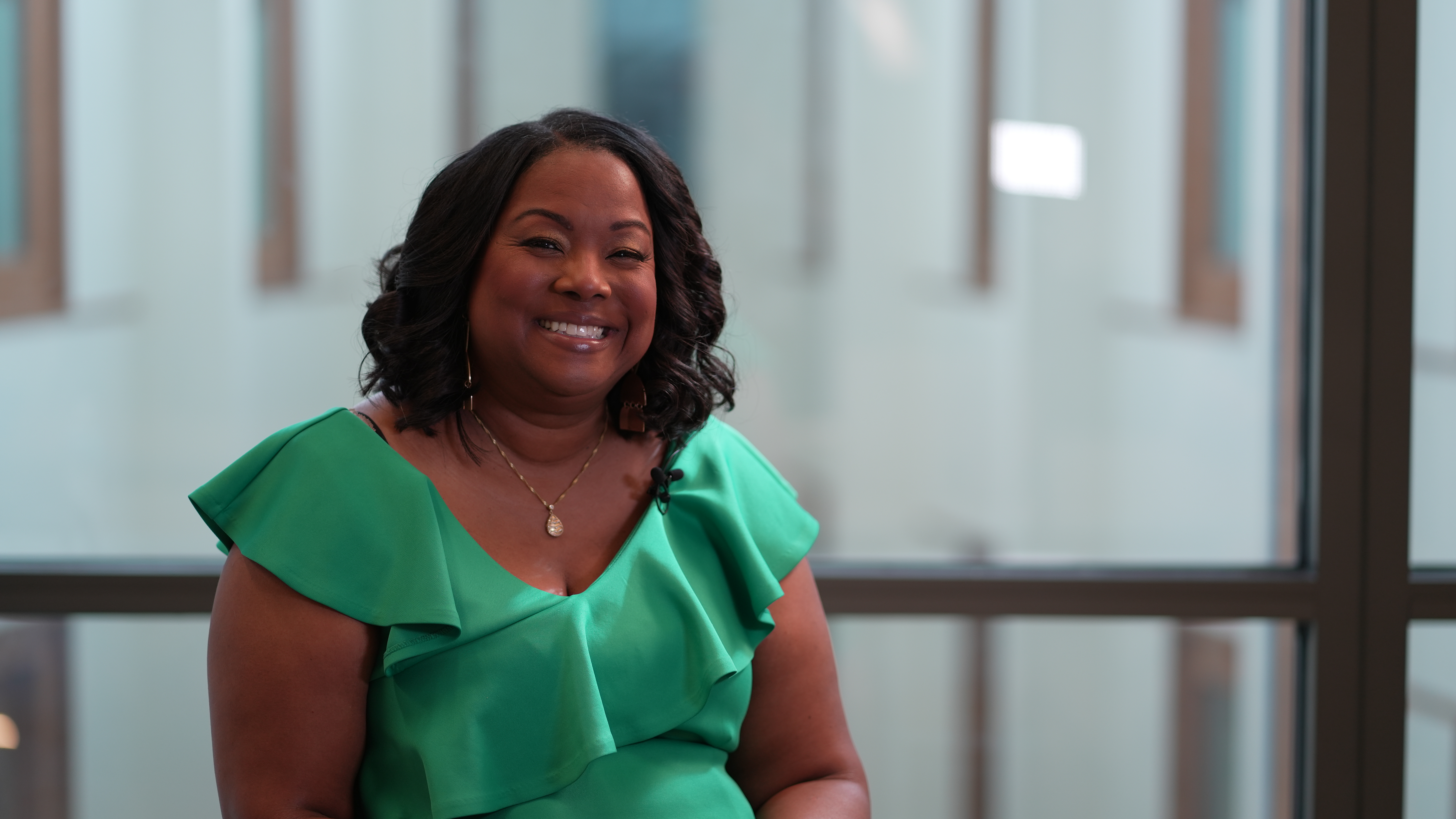 EMBA Alumna Melinda Emerson smiles in a conference room